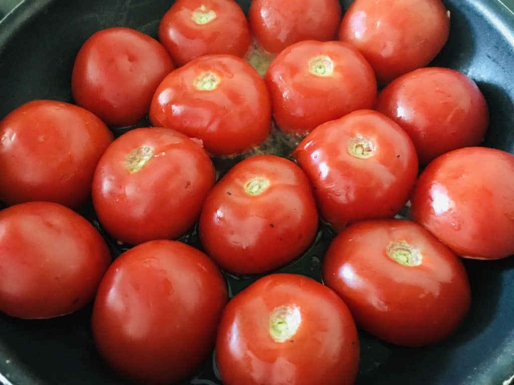 tomatoes face down in a pan