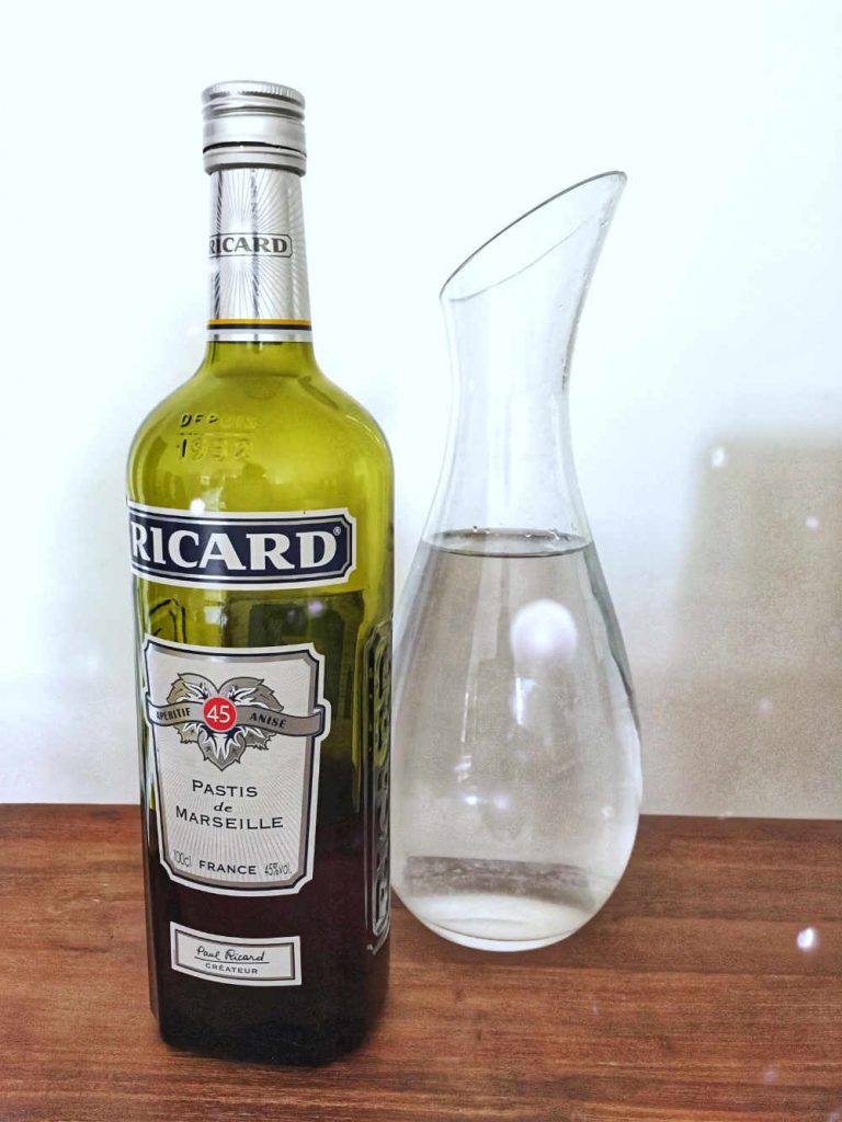 photo of a Pastis bottle and carafe of water