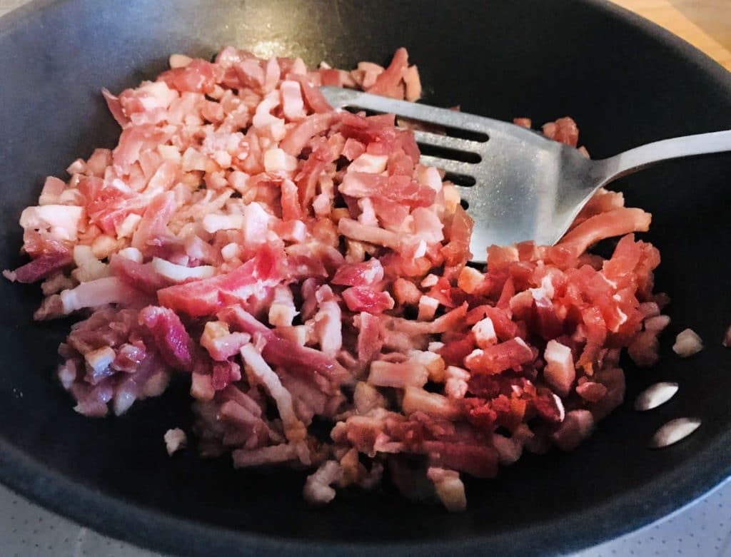 bacon lardons on a pan