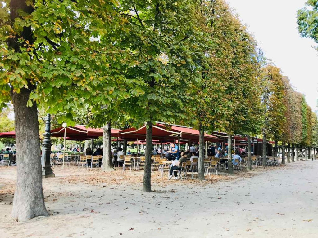 Café and tables among alley of trees in Jardin des Tuileries
