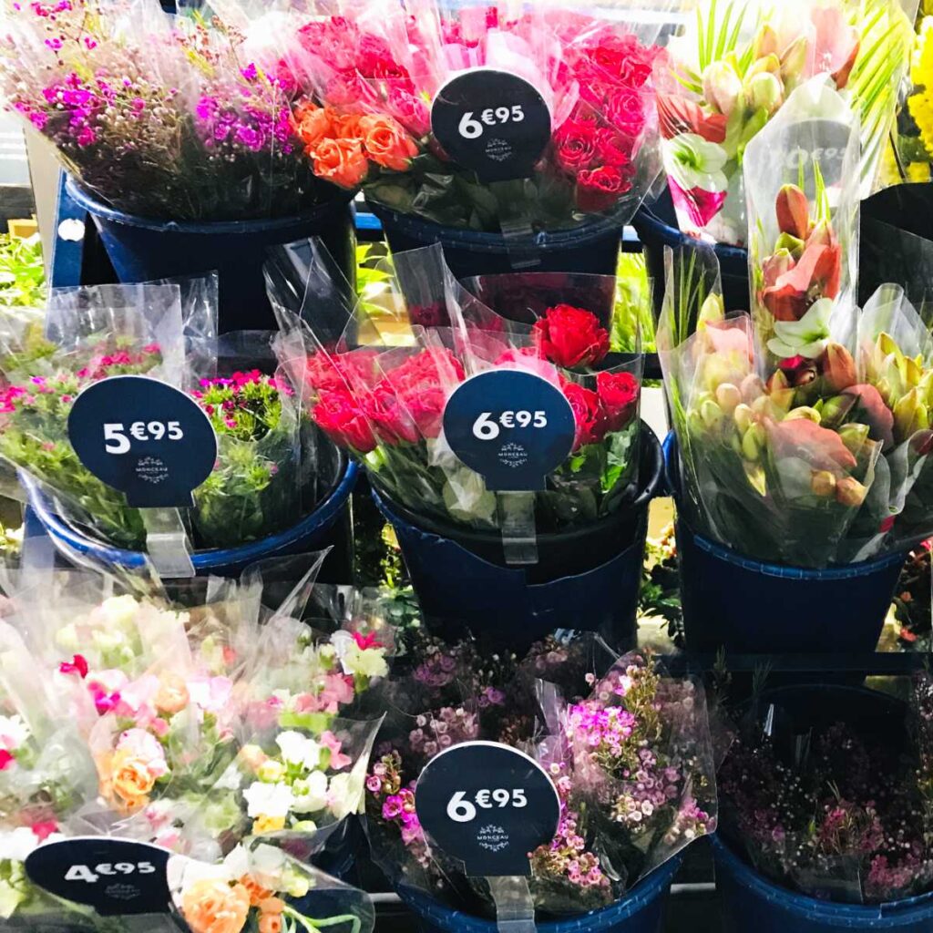 flowers on sale in buckets at a florist